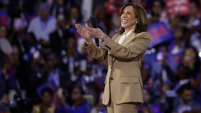 Kamala Harris smiling with microphone