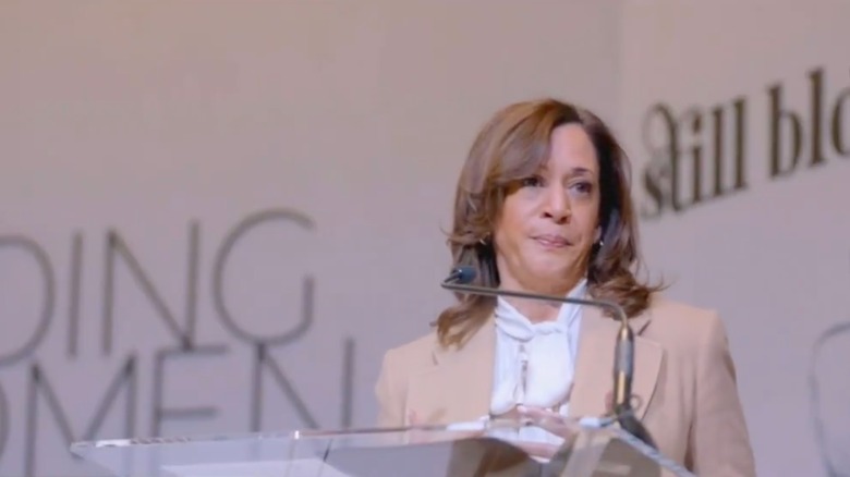 Kamala Harris speaking into microphone