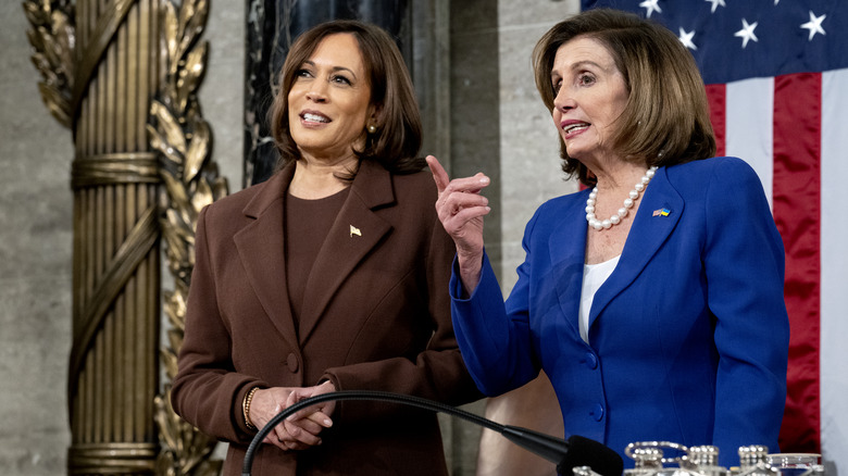 Kamala Harris speaking to Nancy Pelosi at the State of the Union