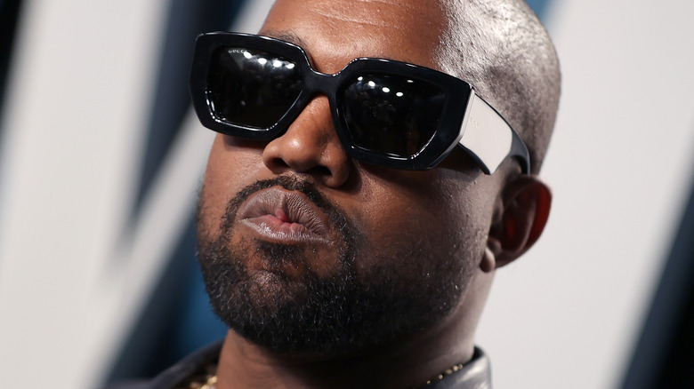 Kanye West posing in sunglasses