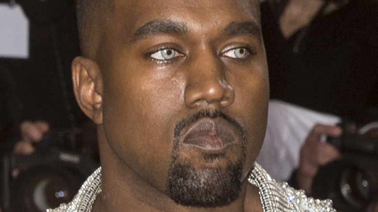 Kanye West frowning on red carpet