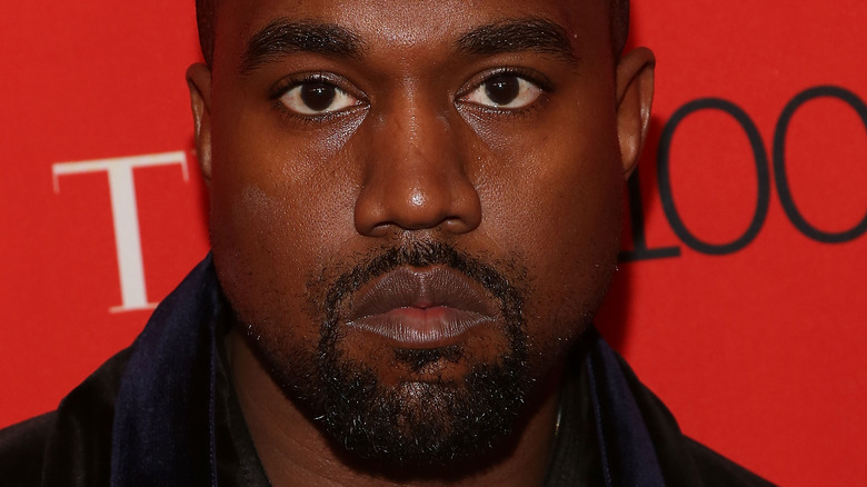 Kanye West frowning on red carpet