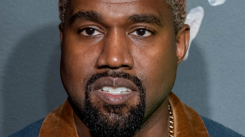 Kanye West smiles red carpet