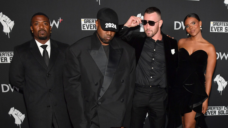 Ray J and Kanye West posing with Candace Owens
