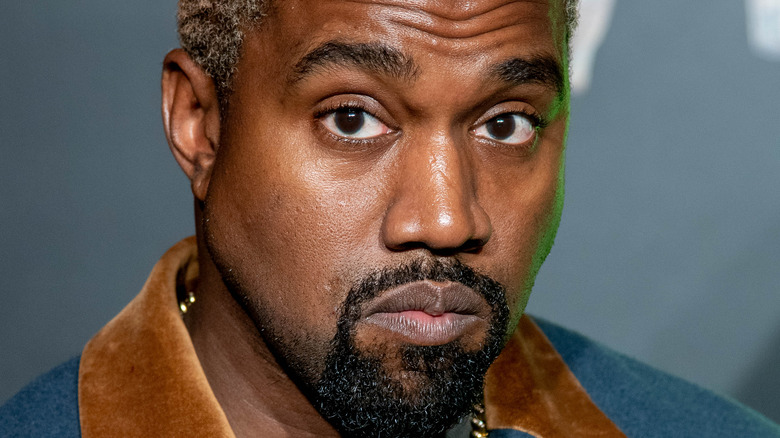 Kanye West frowning at an event