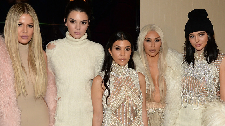 Kourtney Kardashian and Travis Barker smile on the red carpet