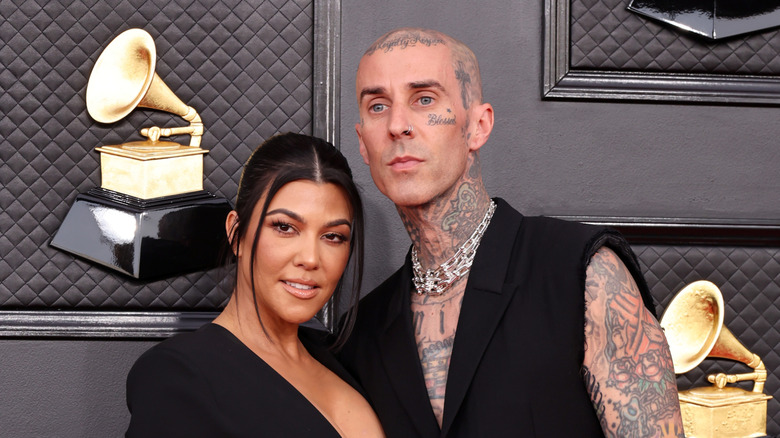 Kourtney Kardashian, Travis Barker posing