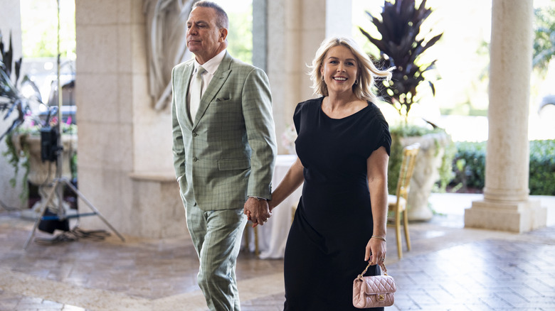 Nicholas Riccio and Karoline Leavitt walking in to Dan Scavino's wedding.