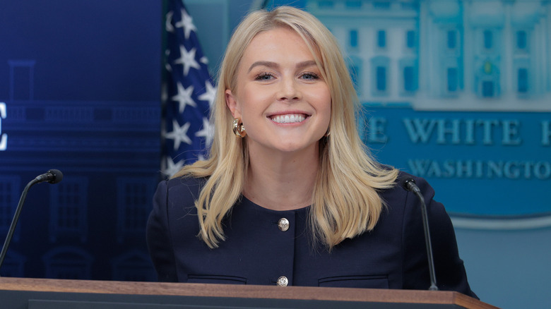 Karoline Leavitt smiles in a White House press briefing.