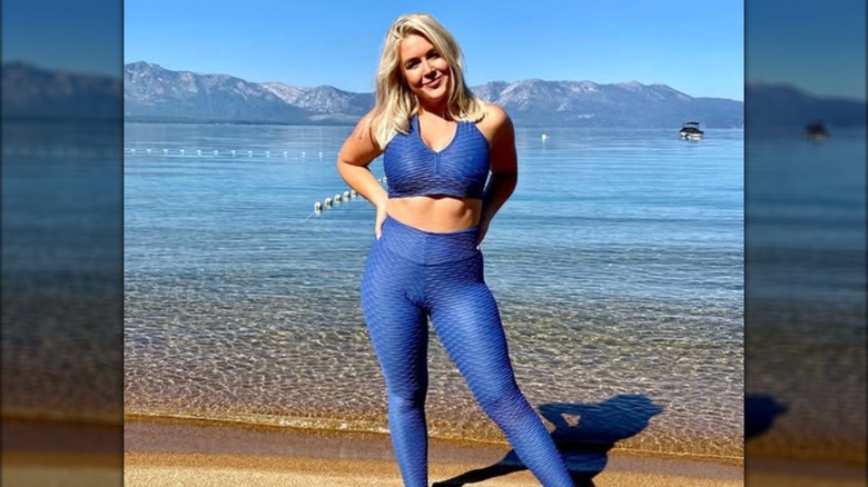 Karoline Leavitt posing in a blue activewear set at Lake Tahoe.