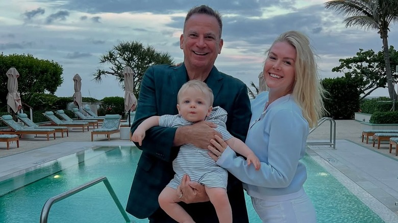Karoline Leavitt poses with husband Nicholas Riccio and son by a pool in Florida
