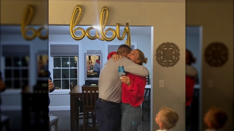 Karoline Leavitt and Nicholas Riccio hug at their gender reveal.