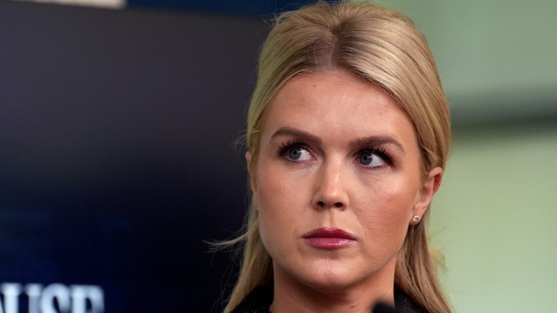 Karoline Leavitt watches Stephen Miller speak at a daily press briefing in the White House on May 1, 2025