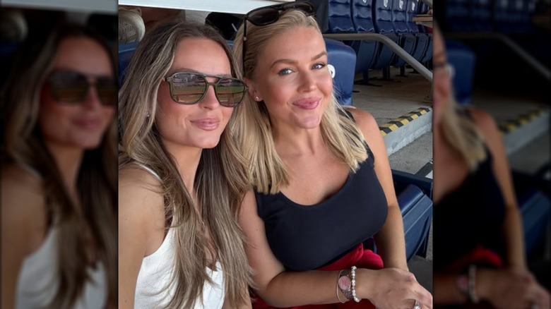 Margo Martin and Karoline Leavitt posing for a selfie at a baseball game.