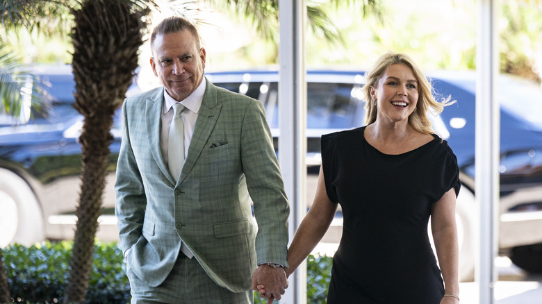 Nicholas Riccio and Karoline Leavitt walking and holding hands.