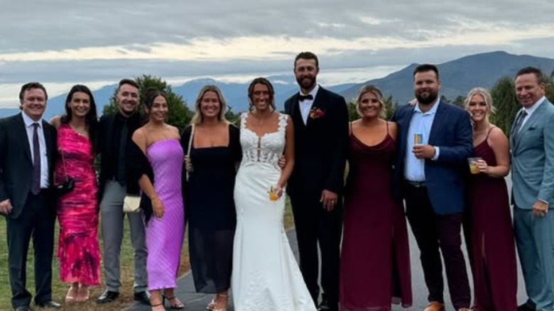 Karoline Leavitt and Nicholas Riccio in a wedding group picture.