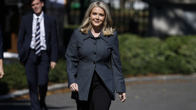 Karoline Leavitt walking towards reporters.