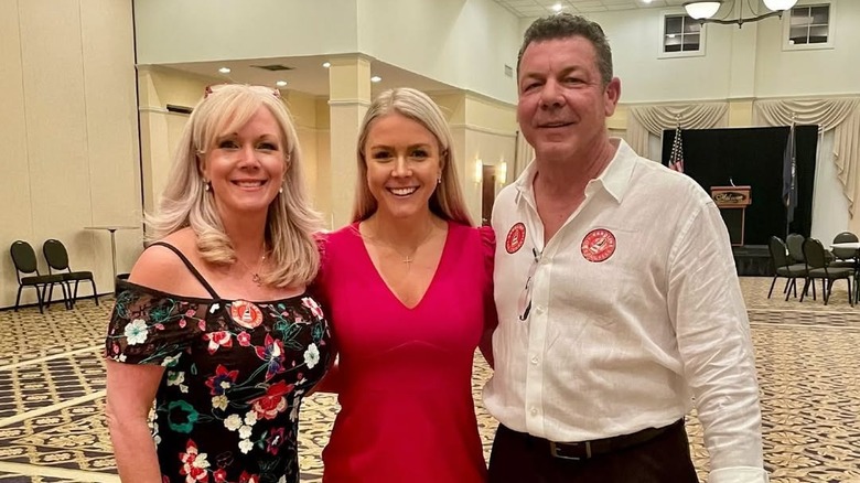 Karoline Leavitt poses with her parents, Erin and Bob