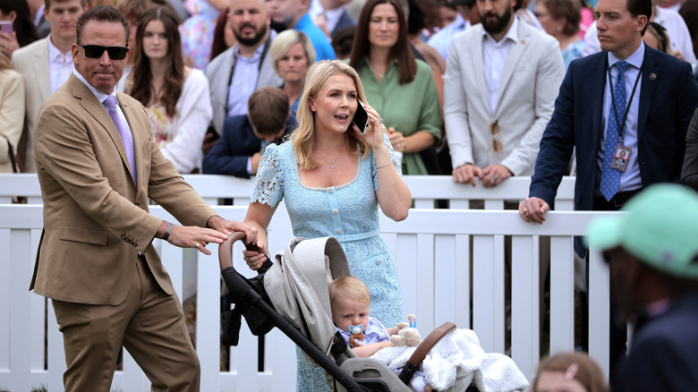 Nicholas Riccio and Karoline Leavitt with their baby in front of a crowd