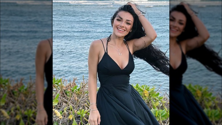 Alexis Wilkins posing in a black dress in Hawaii.