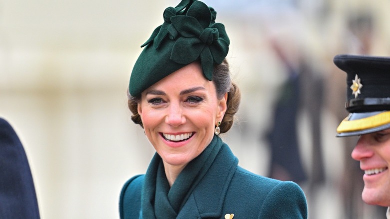 Kate Middleton smiles as she arrives to a St. Patrick's Day event.
