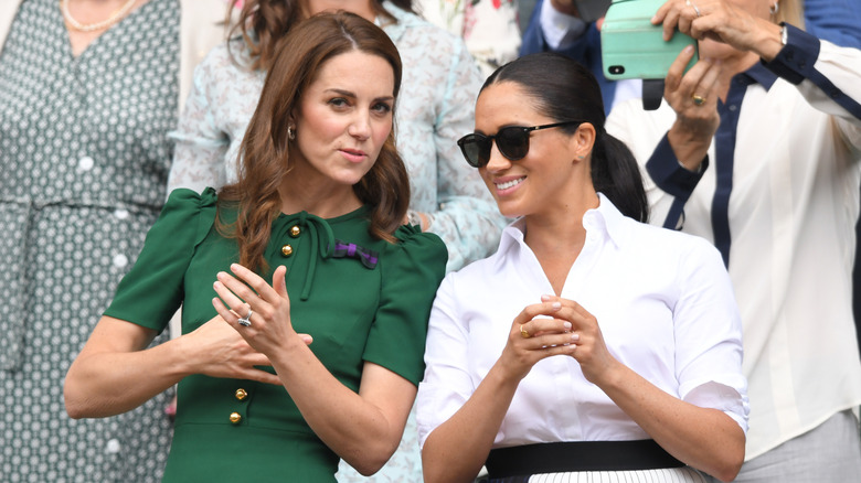 Kate Middleton talking to Meghan Markle
