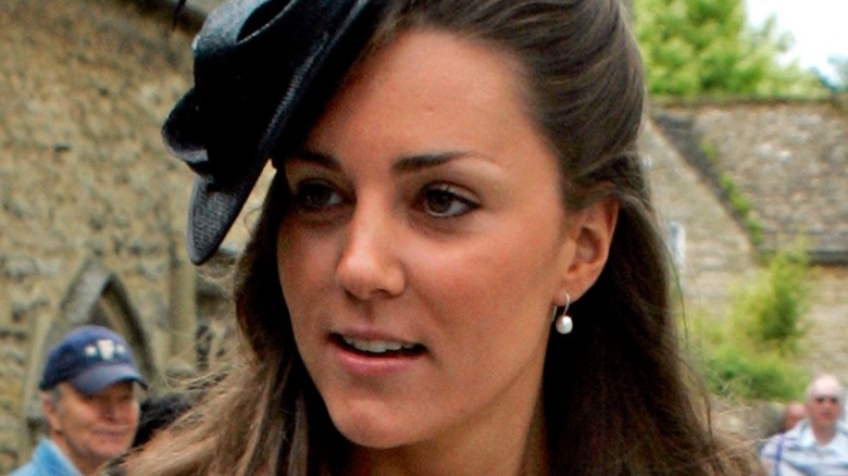 Kate Middleton wearing a black hat in 2005