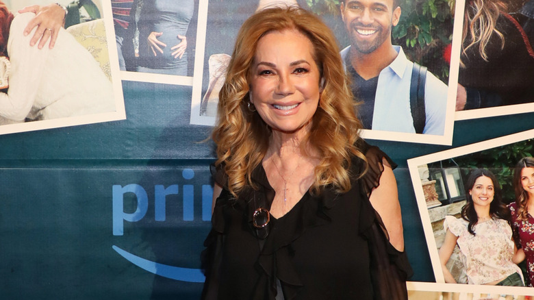 Kathie Lee Gifford smiling while posing at an event in a black dress