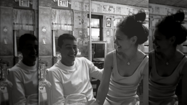 Katie Holmes sitting in Emilio Vitilo Jr.'s lap