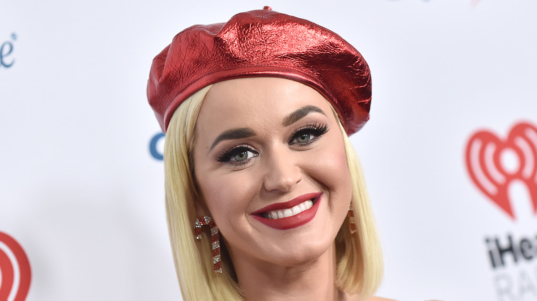 Katy Perry smiling in red hat