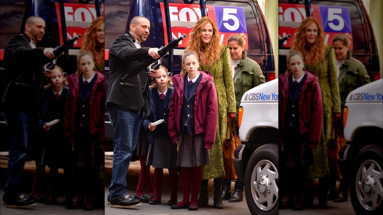 Nicole Kidman and daughters beside news van