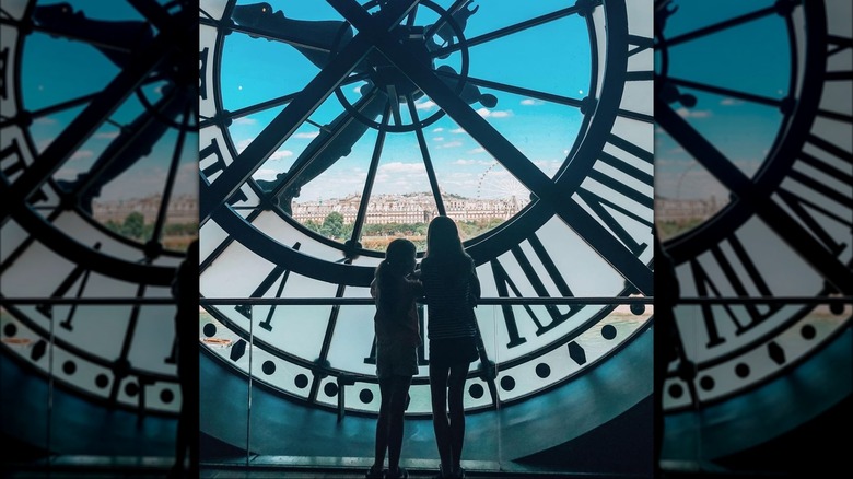 Faith Margaret and Sunday Rose Kidman-Urban behind clock face