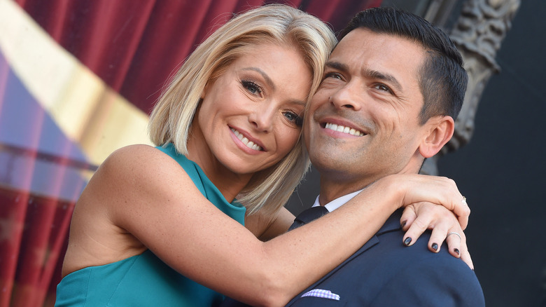 Mark Consuelos and Kelly Ripa embracing