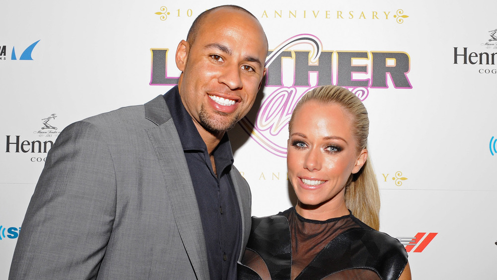 Hank Baskett and Kendra Wilkinson posing together at an event