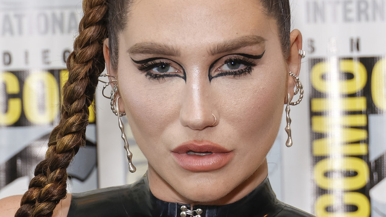 Kesha with hand beside face