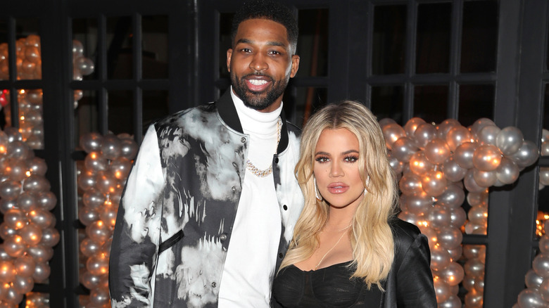 Khloé Kardashian and Tristan Thompson in front of balloons