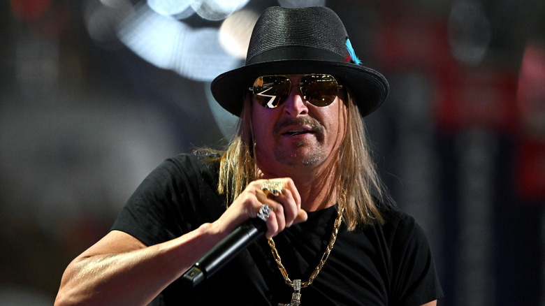 Kid Rock wearing mirrored sunglasses and chain during performance