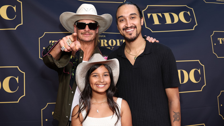 Kid Rock posing with his son Robert James Ritchie Jr. and granddaughter Skye Ritchie at an event