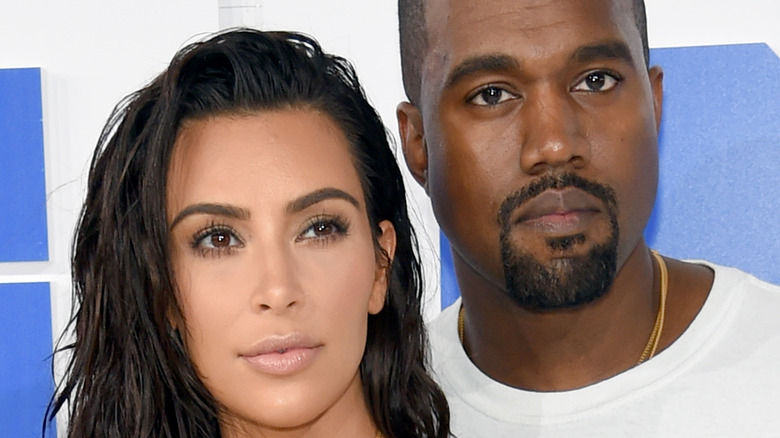 Kim Kardashian and Kanye West with serious expressions