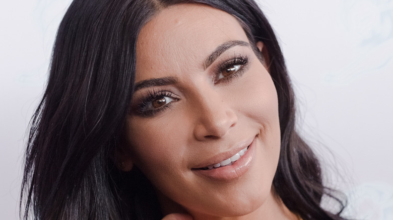 Kim Kardashian smiling with dark hair