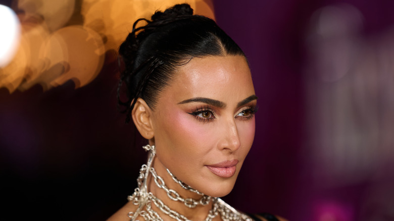 A side profile of Kim Kardashian's face as she poses with her hair up