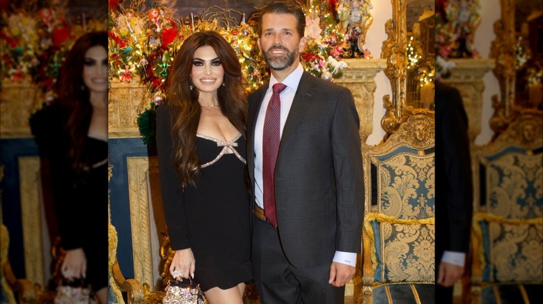 Kimberly Guilfoyle in a tiny black dress posing with Donald Trump Jr