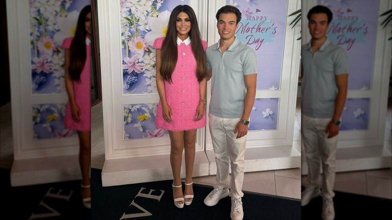 Kimberly Guilfoyle wearing a pink dress and posing with her son