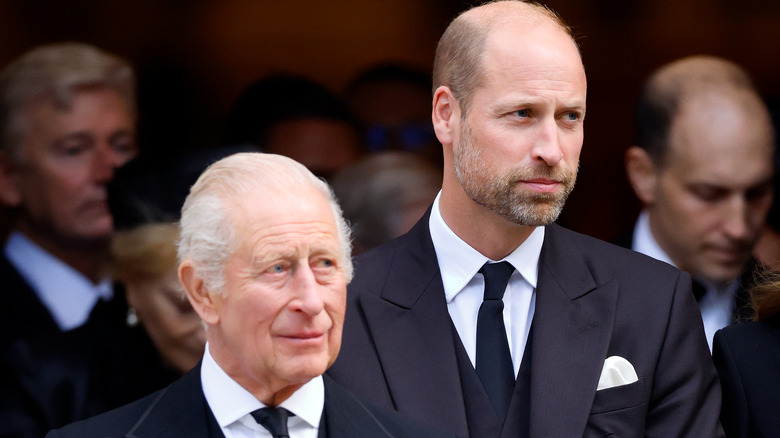 King Charles and Prince William standing among a crowd