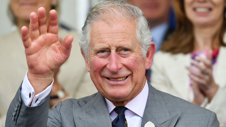 King Charles waving outdoors