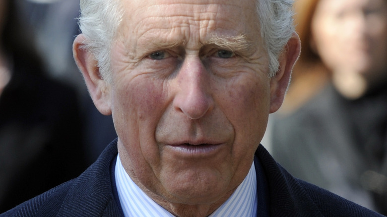 King Charles III frowning