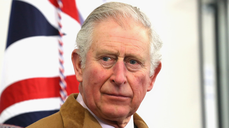 King Charles in beige coat