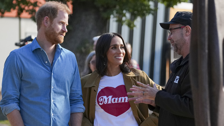 Prince Harry and Meghan Markle speak with a guide during their 2026 visit to Australia.