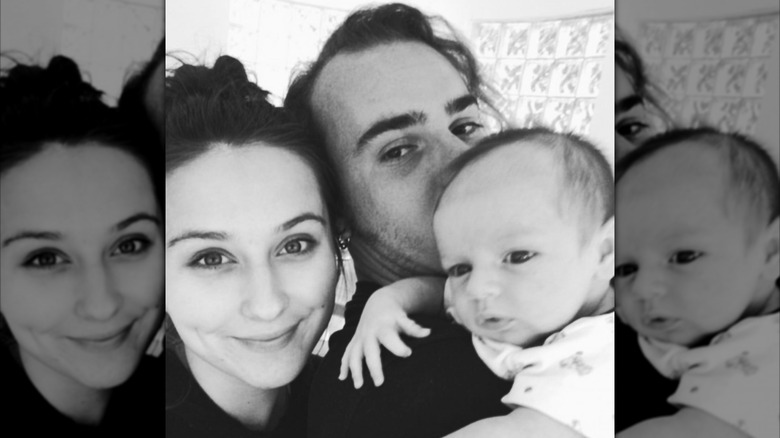 Grayscale selfie of William True Parker (center) with his wife, Sara Parker (left), and one of their babies (right)