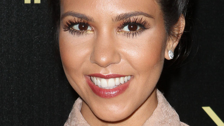 Kourtney Kardashian smiling long fake eyelashes
